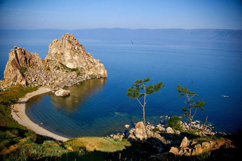 Brown rock by blue sea bay