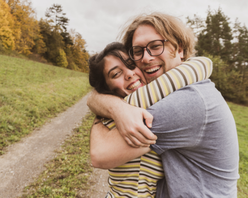 people hugging in nature