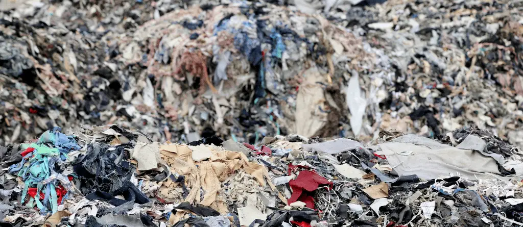 A dump of clothing material waste, piled up as high as the eye can see.