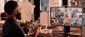 A man engaging remote workers over a video call