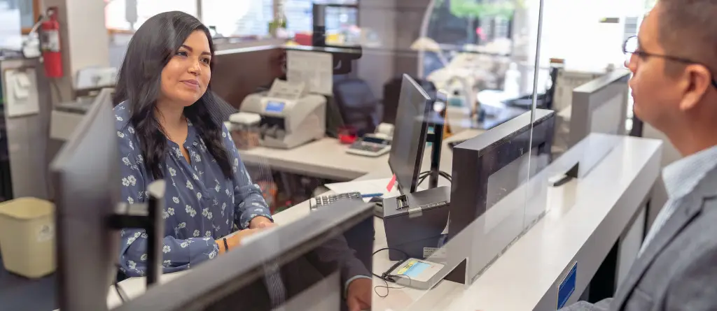 A Bank Teller serving a customer at a branch