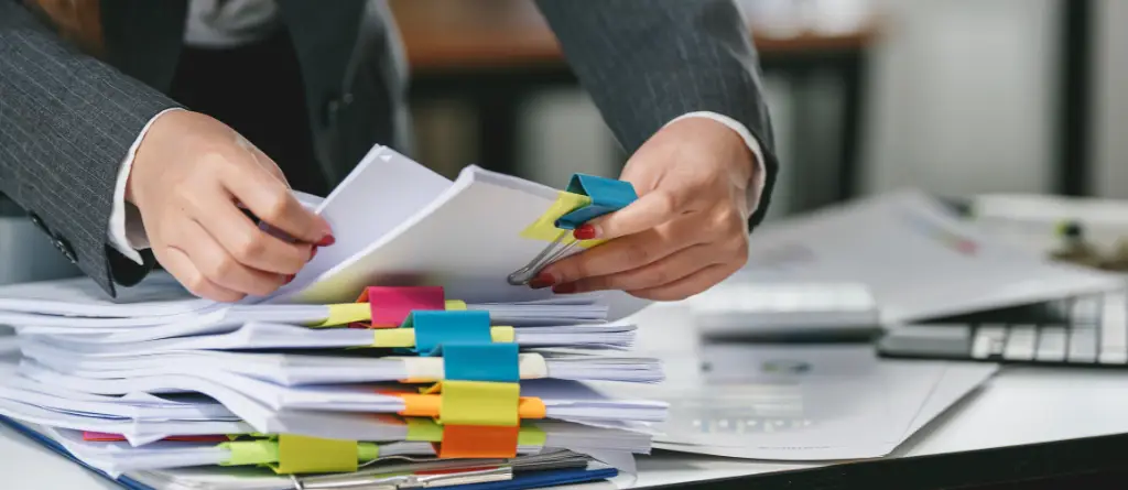 Person organising compliance paperwork
